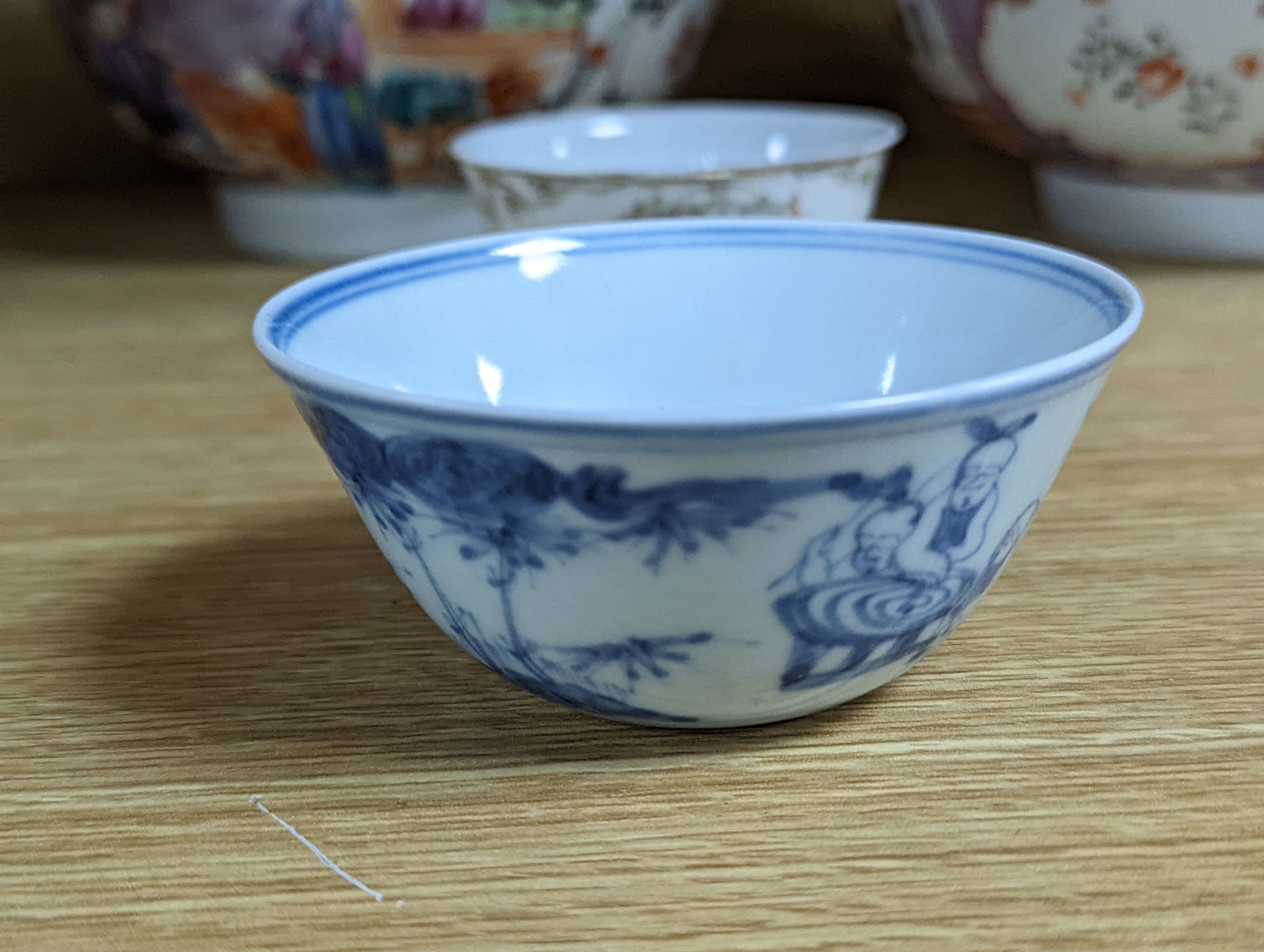 Two 18th century Chinese export bowls, a similar tea bowl and another Chinese blue and white tea bowl, largest 20cm diameter